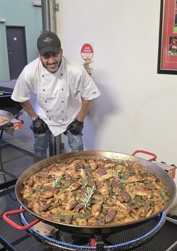 Ignacio cooking live paella at a Melbourne event for Tapas Madriz